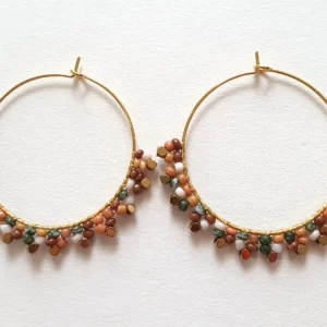 Boucles d'oreilles créoles en perles tissées motif fleur. Vue à plat.